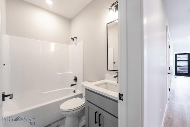 740 Rogers Way Unit A, Bozeman, MT 59718 - full bathroom with vanity, washtub / shower combination, and wood finished floors