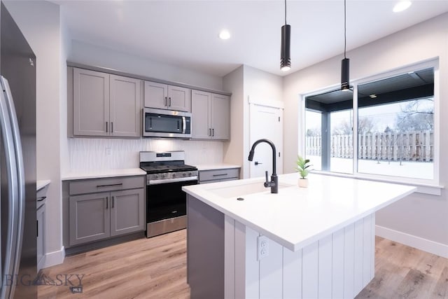 740 Rogers Way Unit A, Bozeman, MT 59718 - kitchen with appliances with stainless steel finishes, gray cabinets, light wood-style floors, light countertops, and recessed lighting