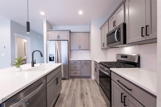 740 Rogers Way Unit A, Bozeman, MT 59718 - kitchen featuring stainless steel appliances, gray cabinets, light wood finished floors, light countertops, and recessed lighting