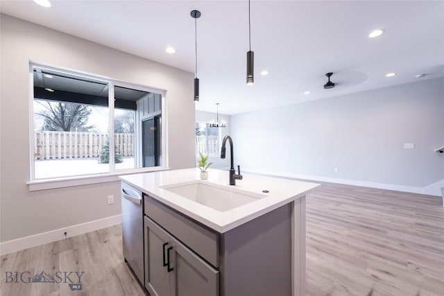 740 Rogers Way Unit A, Bozeman, MT 59718 - kitchen with gray cabinets, stainless steel dishwasher, light wood-style flooring, a center island with sink, and decorative light fixtures