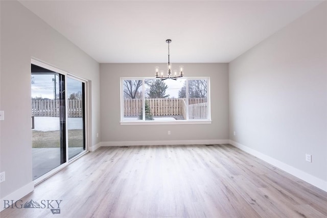 740 Rogers Way Unit A, Bozeman, MT 59718 - unfurnished dining area featuring a chandelier, wood finished floors, and plenty of natural light
