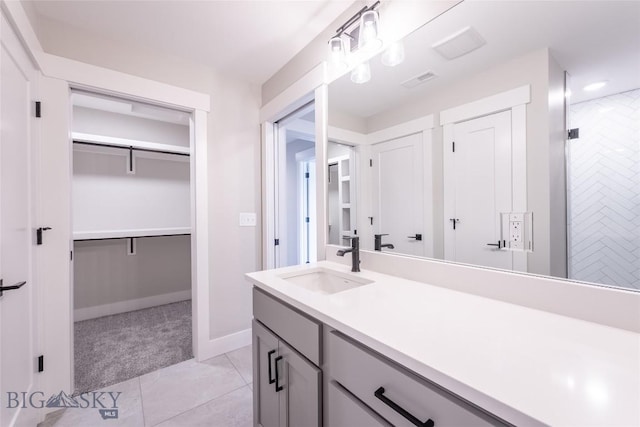 740 Rogers Way Unit A, Bozeman, MT 59718 - full bathroom featuring vanity, a spacious closet, a shower, recessed lighting, and tile patterned floors