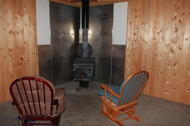 524 Grizzly Meadow Rd, Emigrant, MT 59027 - sitting room with a wood stove, wooden walls, and concrete flooring
