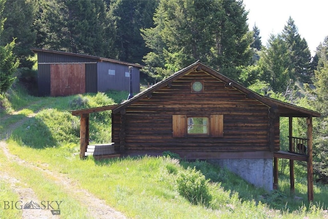 524 Grizzly Meadow Rd, Emigrant, MT 59027 - view of property exterior featuring log siding and a view of trees