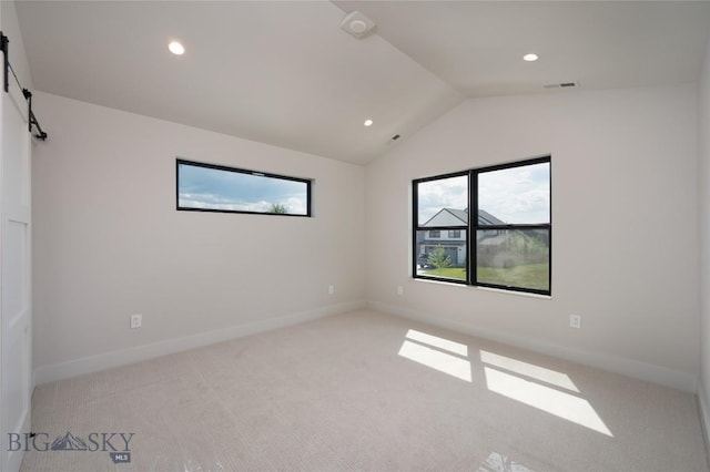 1440 Ryun Sun Way, Bozeman, MT 59718 - carpeted spare room featuring lofted ceiling, recessed lighting, and a barn door