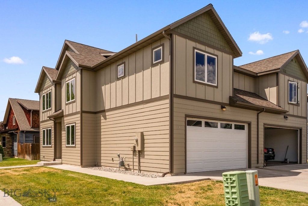 1607 Tempest Ct, Bozeman, MT 59718 - view of home's exterior featuring a garage, board and batten siding, a lawn, and concrete driveway