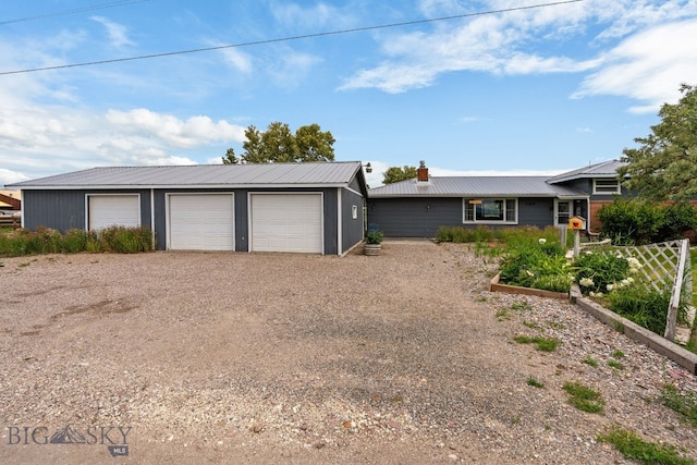 1125 Webster Ln, Dillon, MT 59725 - view of front facade with a garage, a chimney, a metal roof, and an outdoor structure