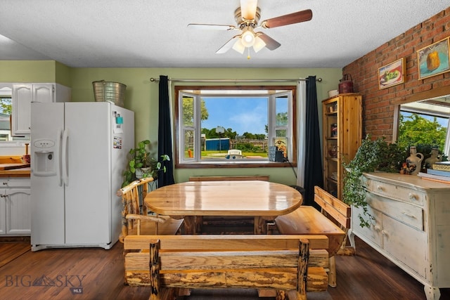 1125 Webster Ln, Dillon, MT 59725 - dining space featuring ceiling fan, wood finished floors, a textured ceiling, plenty of natural light, and brick wall