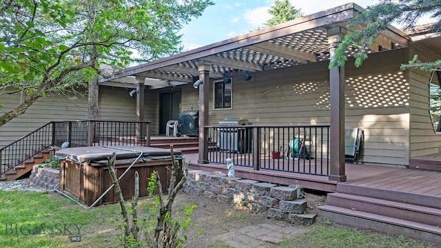 8472 Wagon Boss Rd, Bozeman, MT 59715 - back of property with a hot tub, a deck, and a pergola