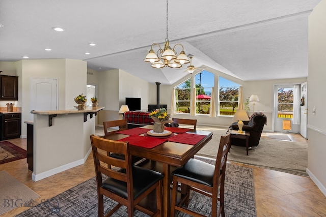 201 N Jackson St, Boulder, MT 59632 - dining space with a wood stove, plenty of natural light, lofted ceiling, recessed lighting, and light tile patterned flooring