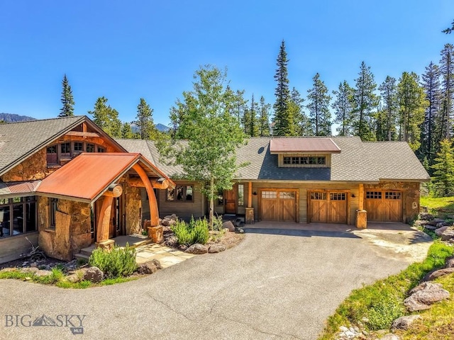 83 Peaks View Dr, Big Sky, MT 59718 - view of front of property with stone siding and driveway