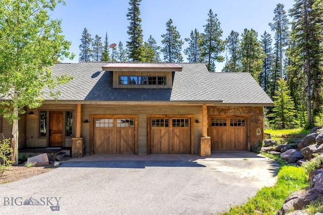 83 Peaks View Dr, Big Sky, MT 59718 - view of front of property with asphalt driveway and an attached garage