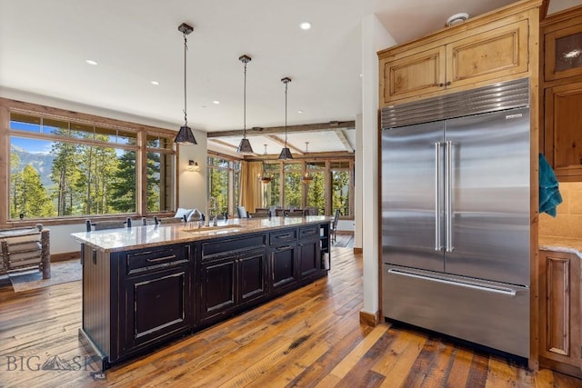 83 Peaks View Dr, Big Sky, MT 59718 - kitchen with stainless steel built in refrigerator, hardwood / wood-style flooring, light stone counters, and recessed lighting