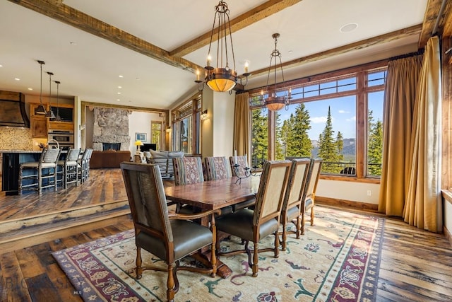 83 Peaks View Dr, Big Sky, MT 59718 - dining room with hardwood / wood-style floors, a chandelier, beamed ceiling, a stone fireplace, and recessed lighting