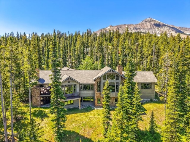 83 Peaks View Dr, Big Sky, MT 59718 - view of subject property with mountains and a forest