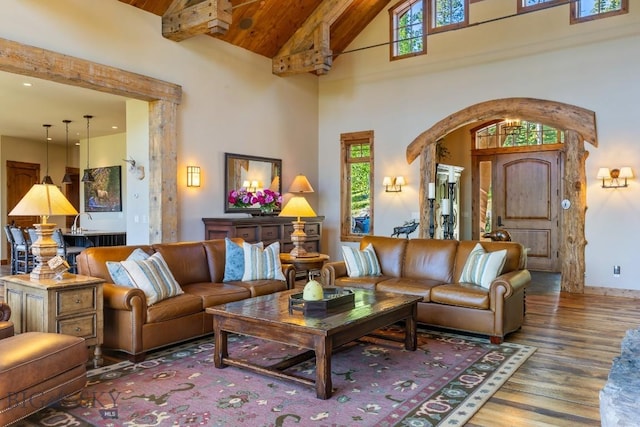 83 Peaks View Dr, Big Sky, MT 59718 - living room with healthy amount of natural light, arched walkways, high vaulted ceiling, wood finished floors, and a wood ceiling with exposed beams