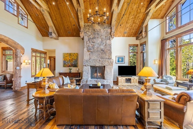 83 Peaks View Dr, Big Sky, MT 59718 - living room featuring high vaulted ceiling, hardwood / wood-style floors, a wood ceiling with exposed beams, arched walkways, and a chandelier
