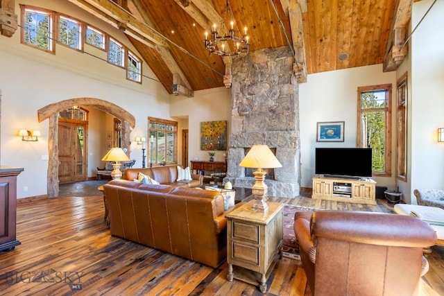 83 Peaks View Dr, Big Sky, MT 59718 - living room featuring high vaulted ceiling, a wood ceiling with exposed beams, hardwood / wood-style flooring, arched walkways, and healthy amount of natural light