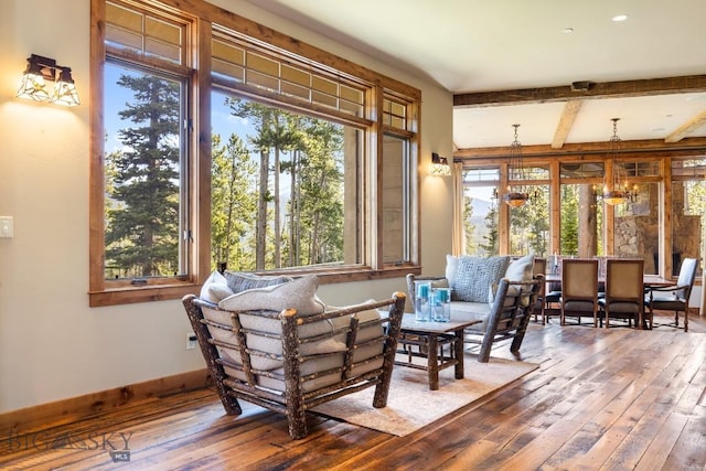 83 Peaks View Dr, Big Sky, MT 59718 - sitting room featuring wood-type flooring, plenty of natural light, beam ceiling, and a chandelier