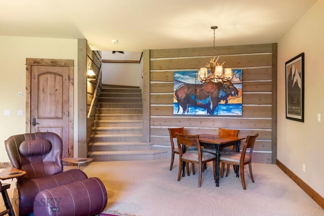 83 Peaks View Dr, Big Sky, MT 59718 - dining room featuring carpet flooring, a chandelier, stairway, and wood walls