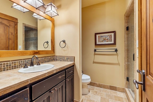 83 Peaks View Dr, Big Sky, MT 59718 - bathroom featuring vanity, stone finish floors, tasteful backsplash, and tiled shower