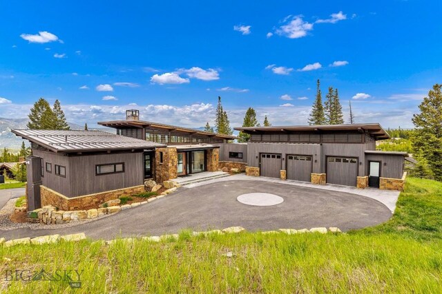 93 Goshawk Trl, Big Sky, MT 59716 - contemporary home featuring stone siding, a standing seam roof, and a metal roof