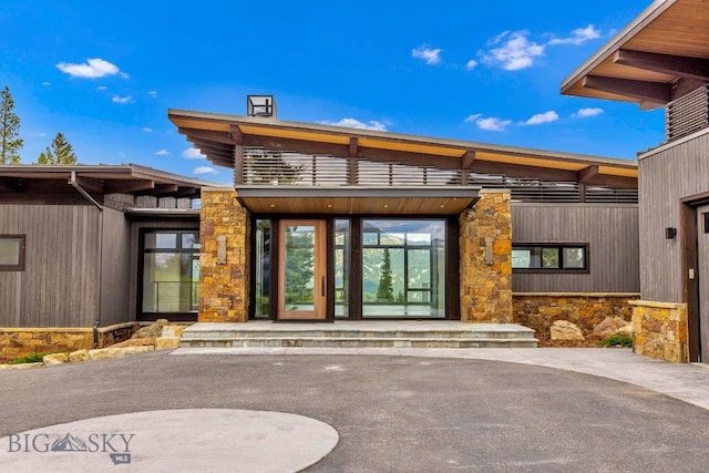93 Goshawk Trl, Big Sky, MT 59716 - view of exterior entry featuring stone siding