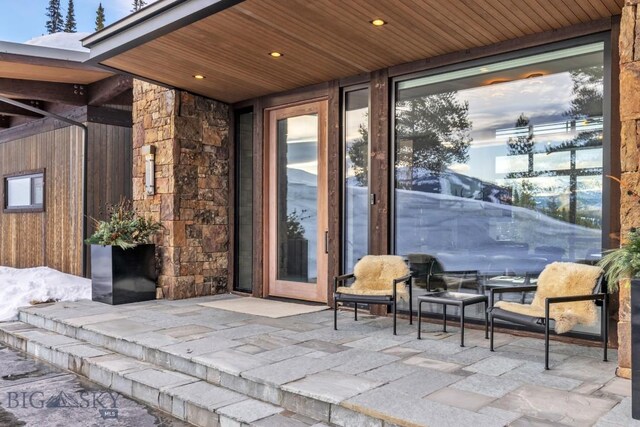 93 Goshawk Trl, Big Sky, MT 59716 - entrance to property featuring a patio area and stone siding