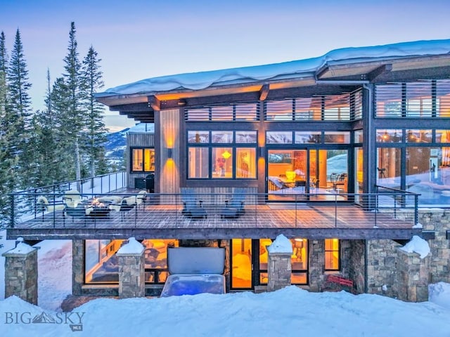 93 Goshawk Trl, Big Sky, MT 59716 - snow covered property featuring a balcony and stone siding