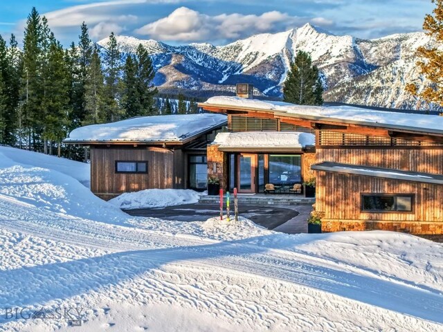 93 Goshawk Trl, Big Sky, MT 59716 - snow covered building featuring a mountain view