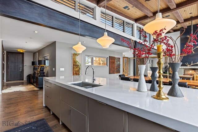 93 Goshawk Trl, Big Sky, MT 59716 - kitchen featuring a wooden ceiling with exposed beams, dark wood-style floors, gray cabinets, decorative light fixtures, and modern cabinets