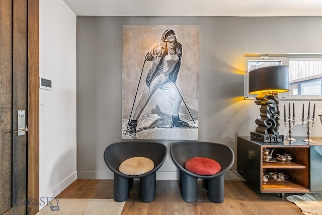 93 Goshawk Trl, Big Sky, MT 59716 - sitting room featuring wood finished floors and baseboards