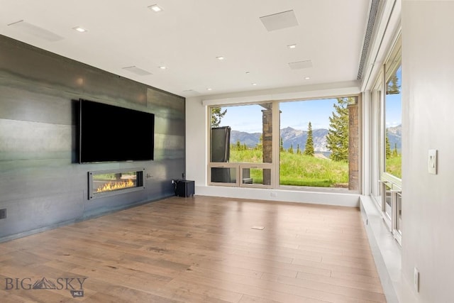 93 Goshawk Trl, Big Sky, MT 59716 - unfurnished living room with a fireplace and wood finished floors