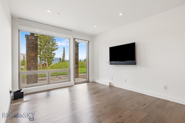 93 Goshawk Trl, Big Sky, MT 59716 - unfurnished living room featuring wood finished floors and recessed lighting