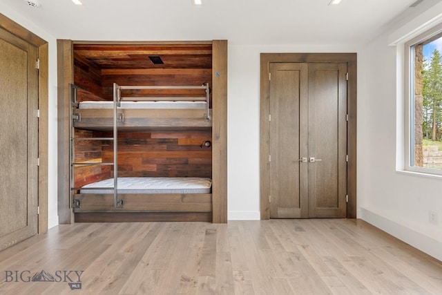 93 Goshawk Trl, Big Sky, MT 59716 - unfurnished bedroom with wood finished floors