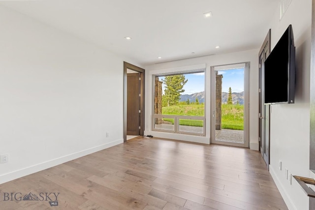 93 Goshawk Trl, Big Sky, MT 59716 - empty room with light wood finished floors and recessed lighting