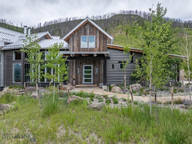 225 Alpen Strasse St, Bozeman, MT 59715 - view of front facade with a metal roof, a mountain view, a standing seam roof, and a chimney