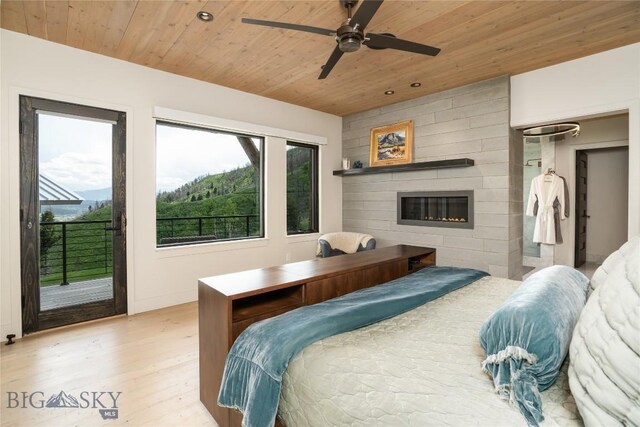 225 Alpen Strasse St, Bozeman, MT 59715 - bedroom with wood ceiling, access to outside, wood finished floors, a large fireplace, and recessed lighting