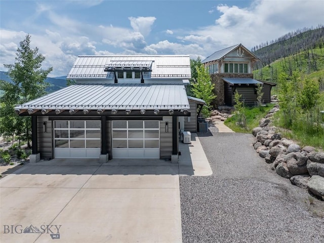 225 Alpen Strasse St, Bozeman, MT 59715 - view of front of property with driveway, a standing seam roof, a metal roof, and a garage