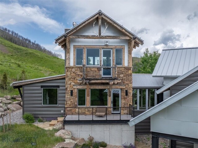 225 Alpen Strasse St, Bozeman, MT 59715 - back of property featuring stone siding, a metal roof, and a standing seam roof