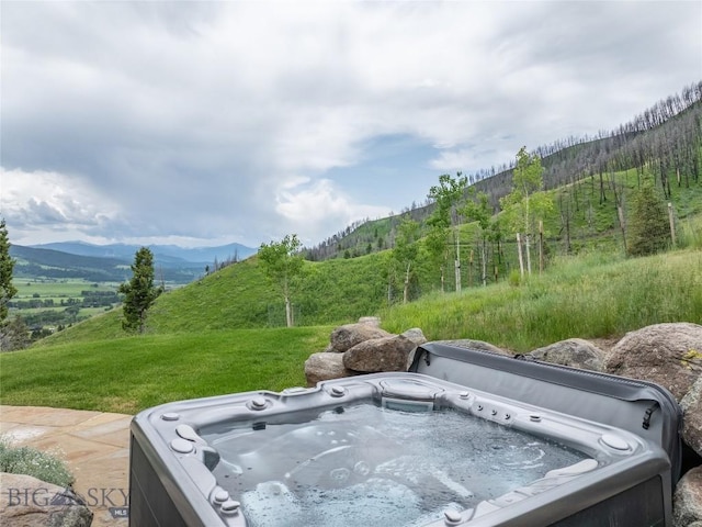225 Alpen Strasse St, Bozeman, MT 59715 - exterior view of a hot tub and a mountain backdrop