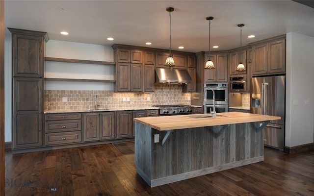 661 Doney Way, Bozeman, MT 59718 - kitchen featuring stainless steel appliances, butcher block countertops, exhaust hood, open shelves, and a center island with sink