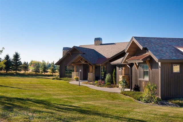 661 Doney Way, Bozeman, MT 59718 - craftsman inspired home with a chimney, a front lawn, a shingled roof, and board and batten siding