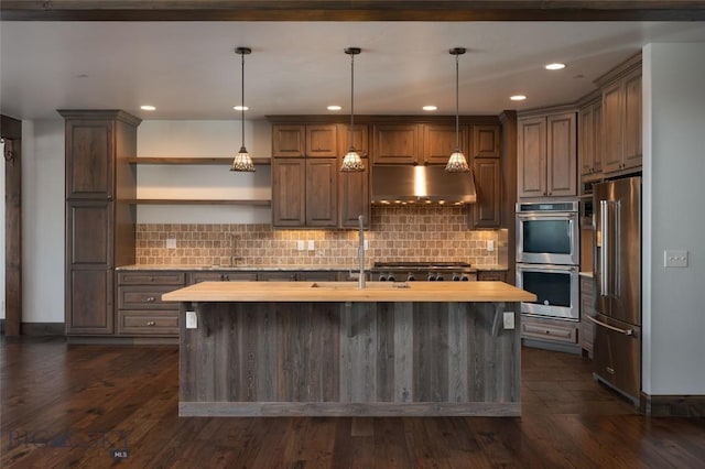 661 Doney Way, Bozeman, MT 59718 - kitchen with appliances with stainless steel finishes, exhaust hood, a center island with sink, tasteful backsplash, and recessed lighting