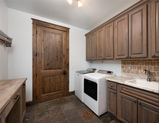 661 Doney Way, Bozeman, MT 59718 - washroom featuring washer and dryer, cabinet space, and dark stone finish floors