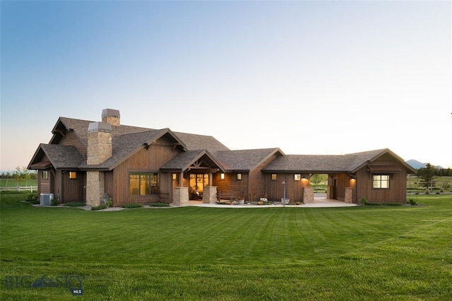 661 Doney Way, Bozeman, MT 59718 - rear view of property with a chimney, a lawn, and stone siding