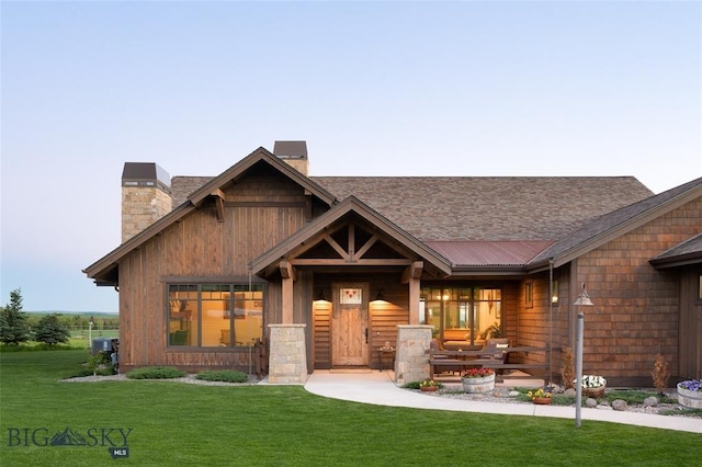 661 Doney Way, Bozeman, MT 59718 - view of front of house featuring a chimney, a front yard, covered porch, and a shingled roof