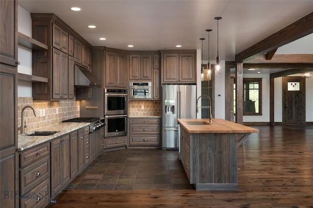 661 Doney Way, Bozeman, MT 59718 - kitchen featuring appliances with stainless steel finishes, wood counters, open shelves, recessed lighting, and backsplash