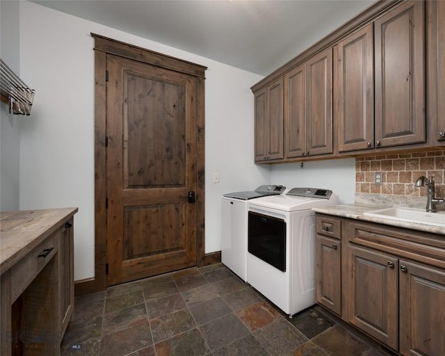 661 Doney Way, Bozeman, MT 59718 - laundry area featuring independent washer and dryer, cabinet space, and dark stone finish flooring
