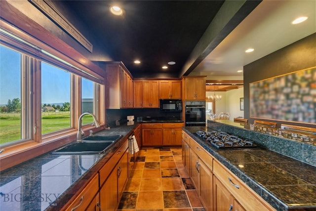 619 Terrance Loop, Bozeman, MT 59718 - kitchen with black appliances, tile counters, brown cabinets, recessed lighting, and tasteful backsplash